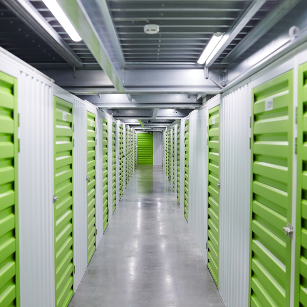 Modern self-storage facility with green roll-up doors